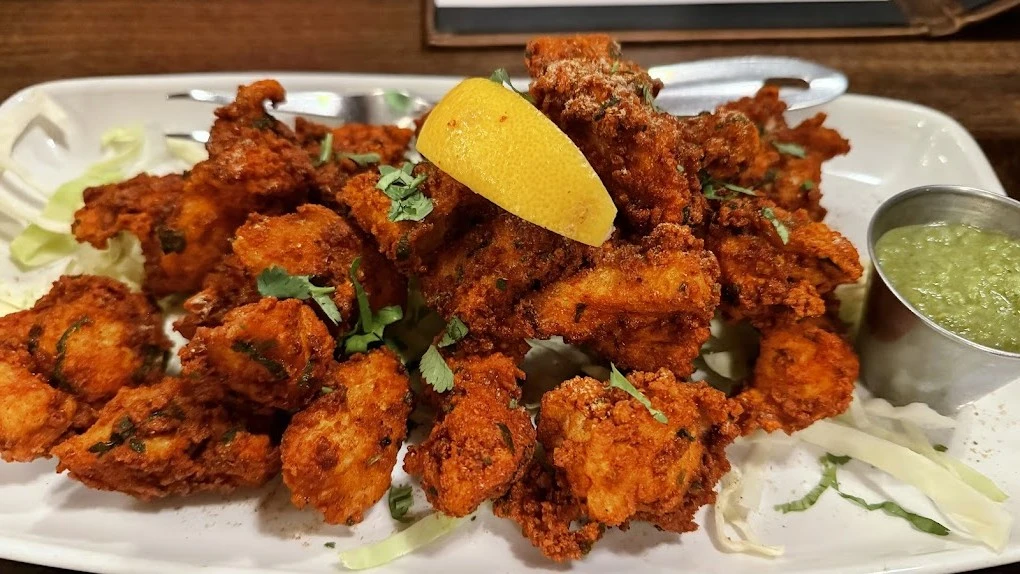Haweli Indian Kitchen and Bar South Common Edmonton – signature North Indian dishes including butter chicken, biryani, and tandoori platters